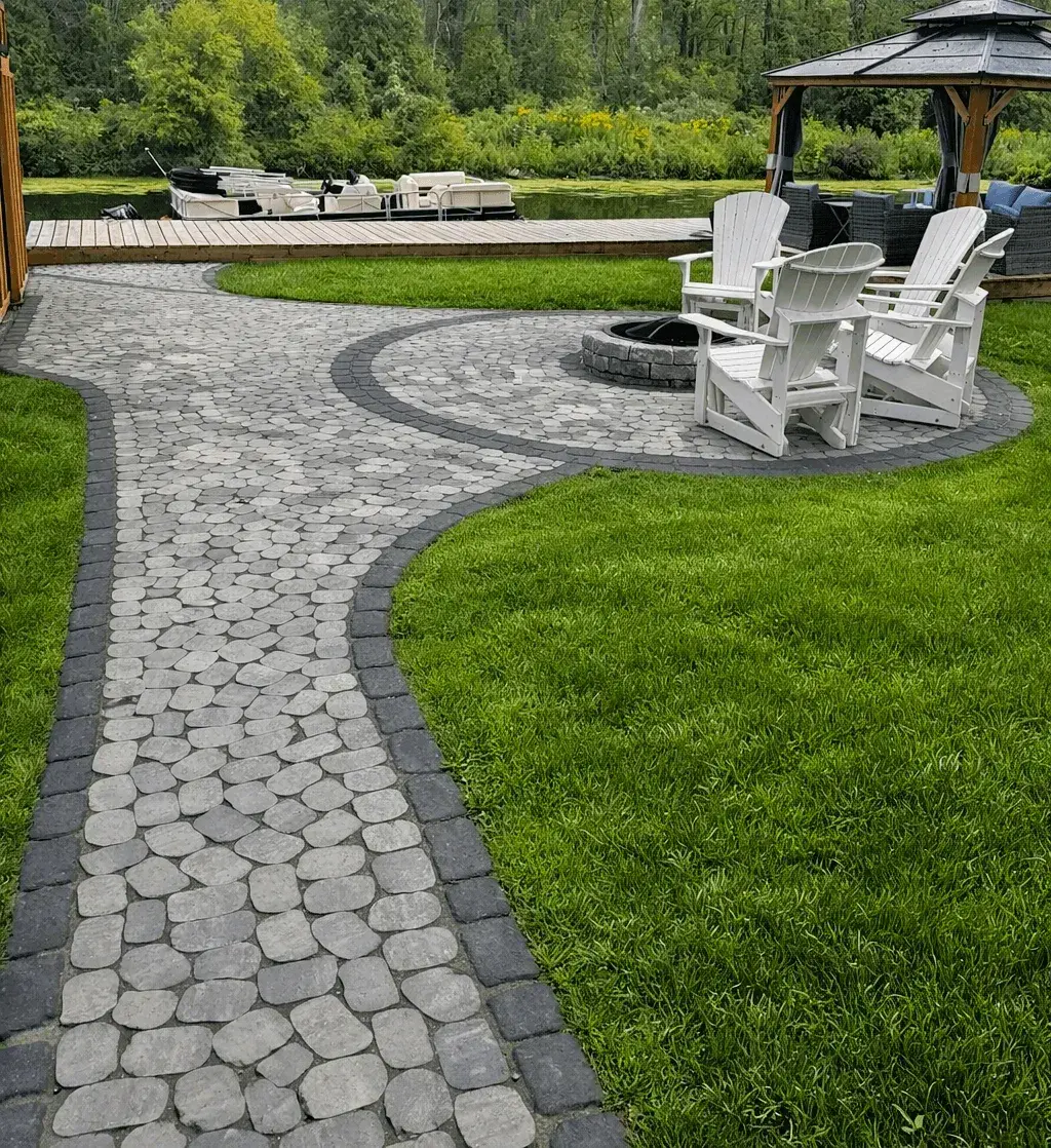 A completed Golden Maple Landscaping patio and fire pit on a waterfront property